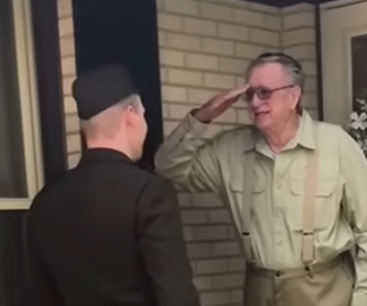 A grandfather salutes his grandson in the army. 